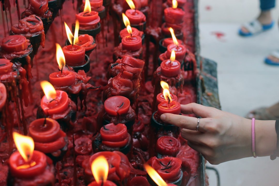 Friendship memorial: hand holding red candle