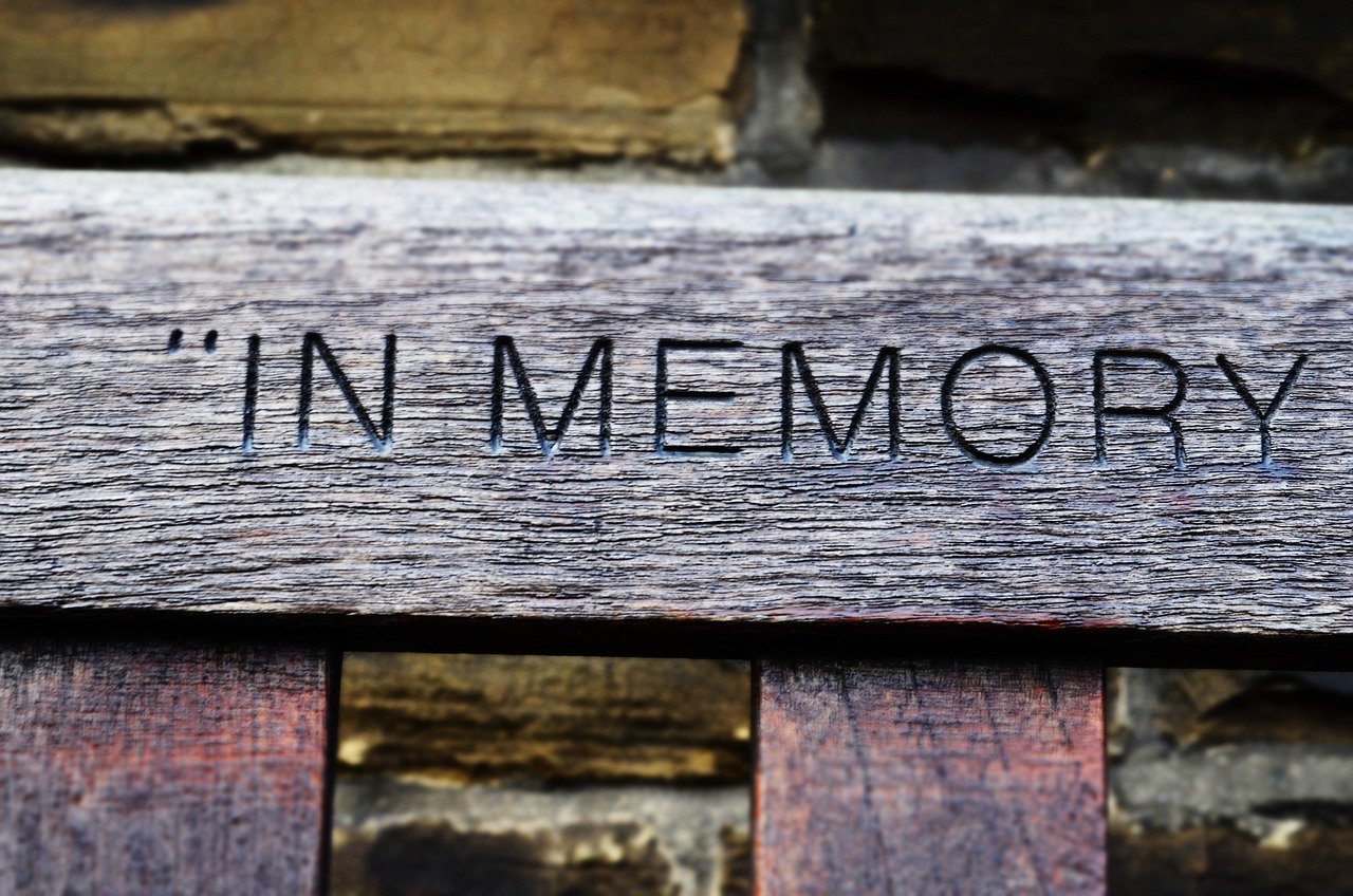 Maintain wooden bar memorial plate in cemetery.