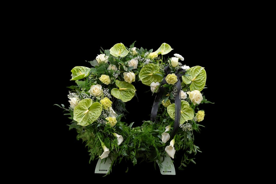 White and green floral arrangement, memorial page sharing steps.