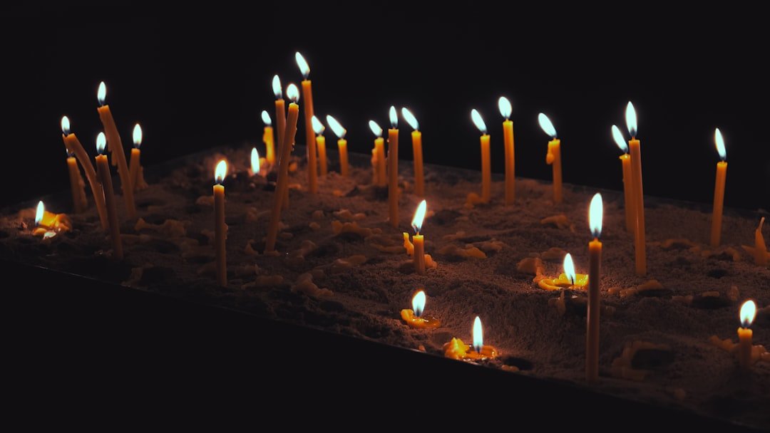 Candles glowing in dark for modern memorial service.