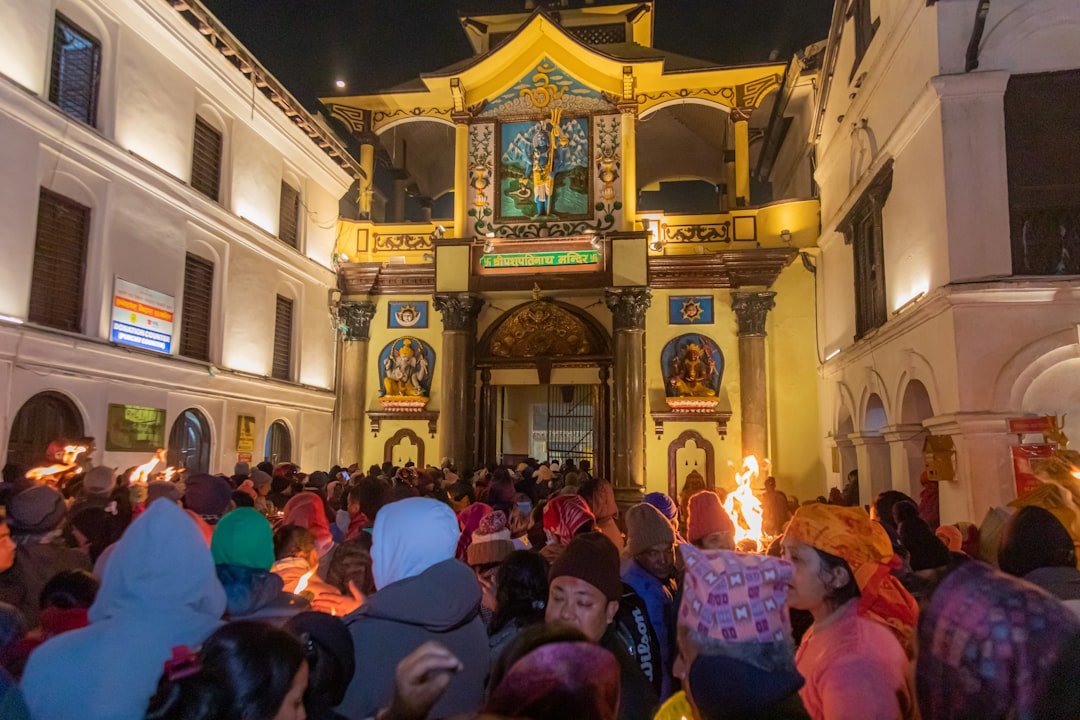 Night temple crowd, faith, heritage, farewell traditions.