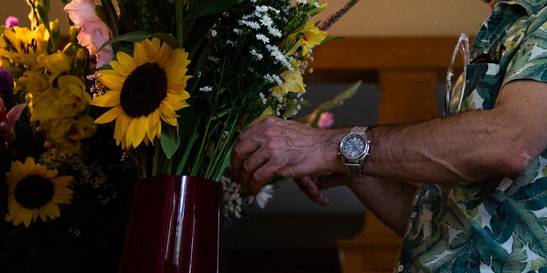Man holding flowers, goodbye letter to deceased in-laws.