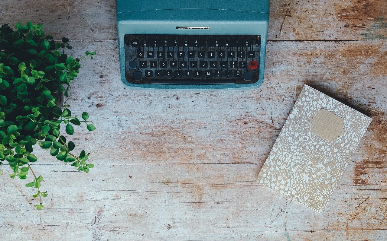 Vintage typewriter, plant, book: Writing after traumatic loss.