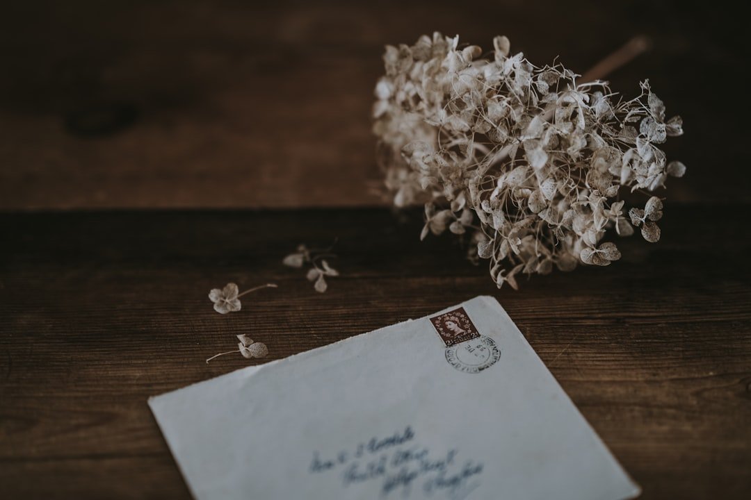 White envelope, delicate white flower, unsaid goodbyes.